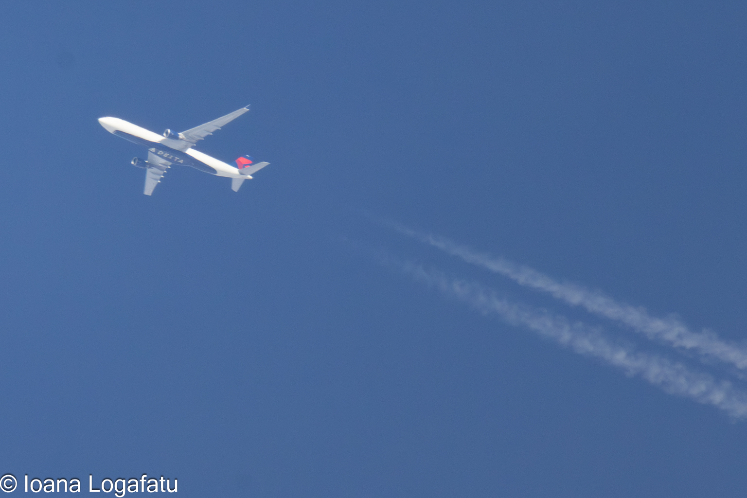 Airplane soaring through a clear blue sky